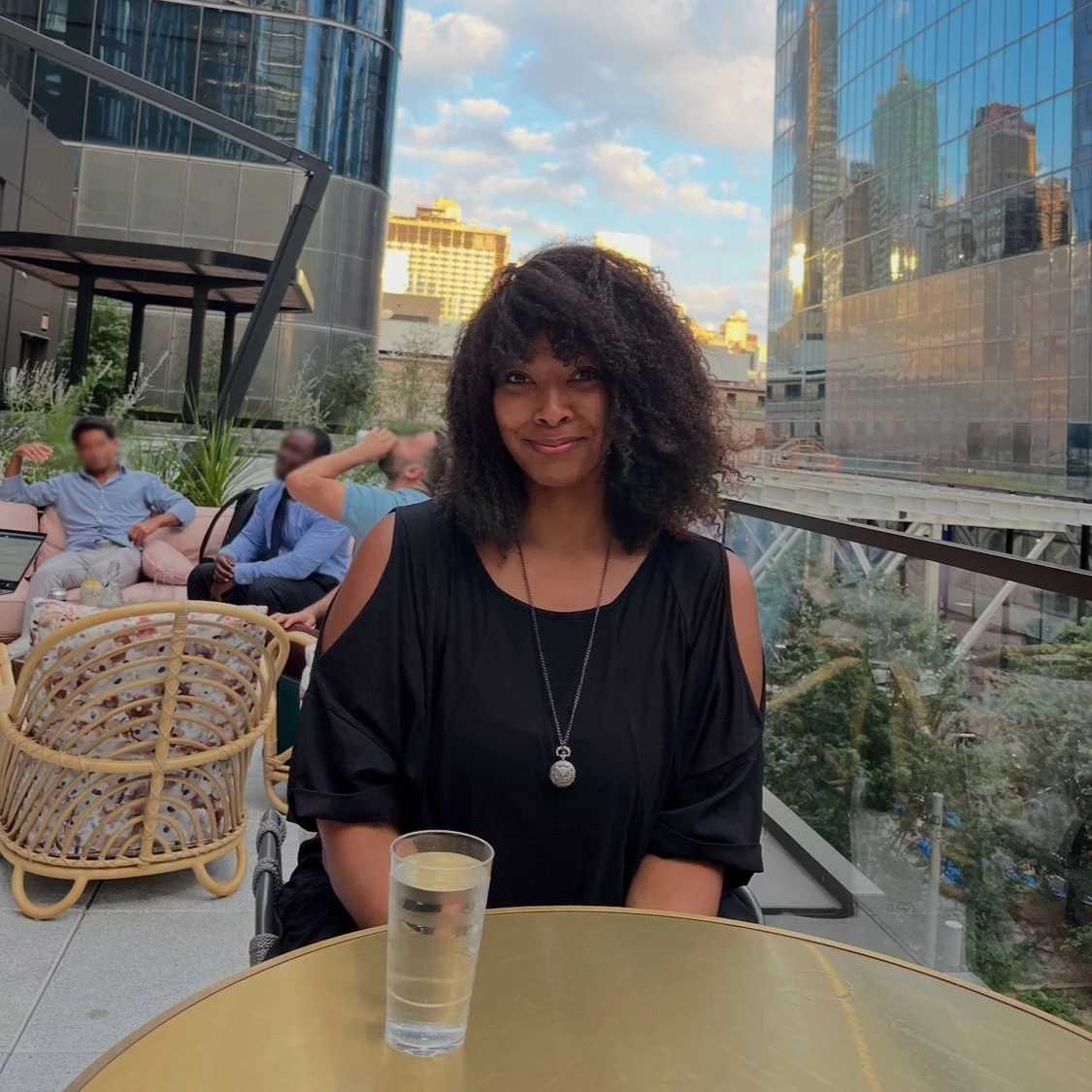 Ryann, Black web designer and developer, on a Brooklyn rooftop with NYC skyline